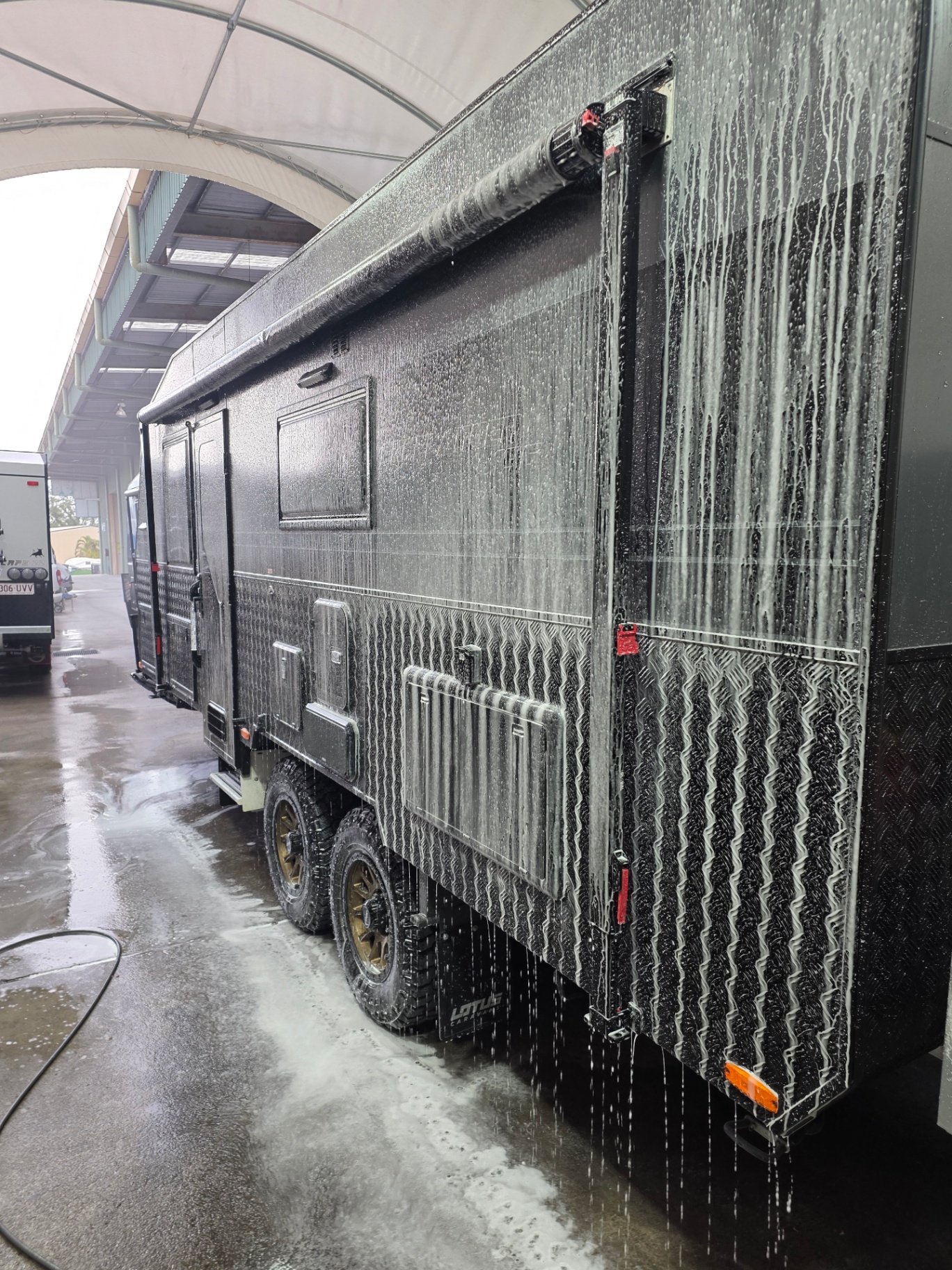 Caravan exterior being decontaminated before machine correction